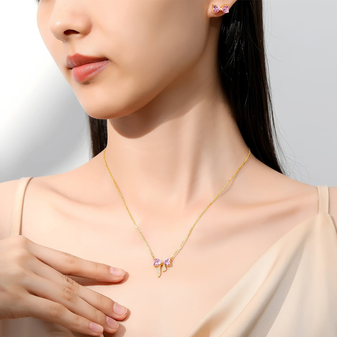 dainty gold plated bow shaped pink zirconia stone stud earrings