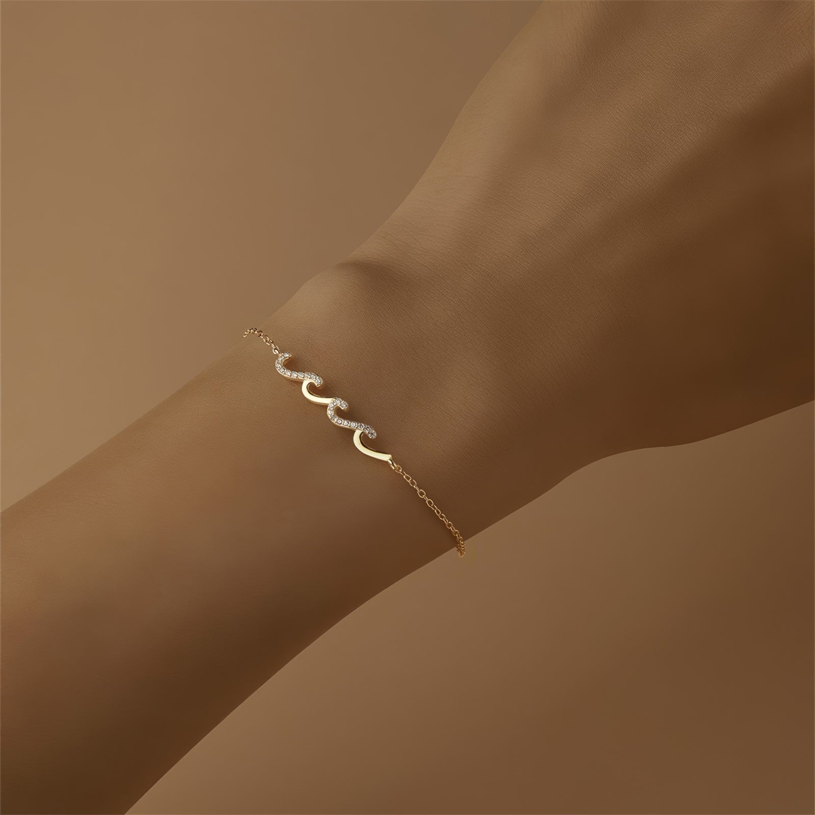 Gold bracelet with wave-shaped zircon design centerpiece on a sterling silver chain, finished with 18K gold plating.