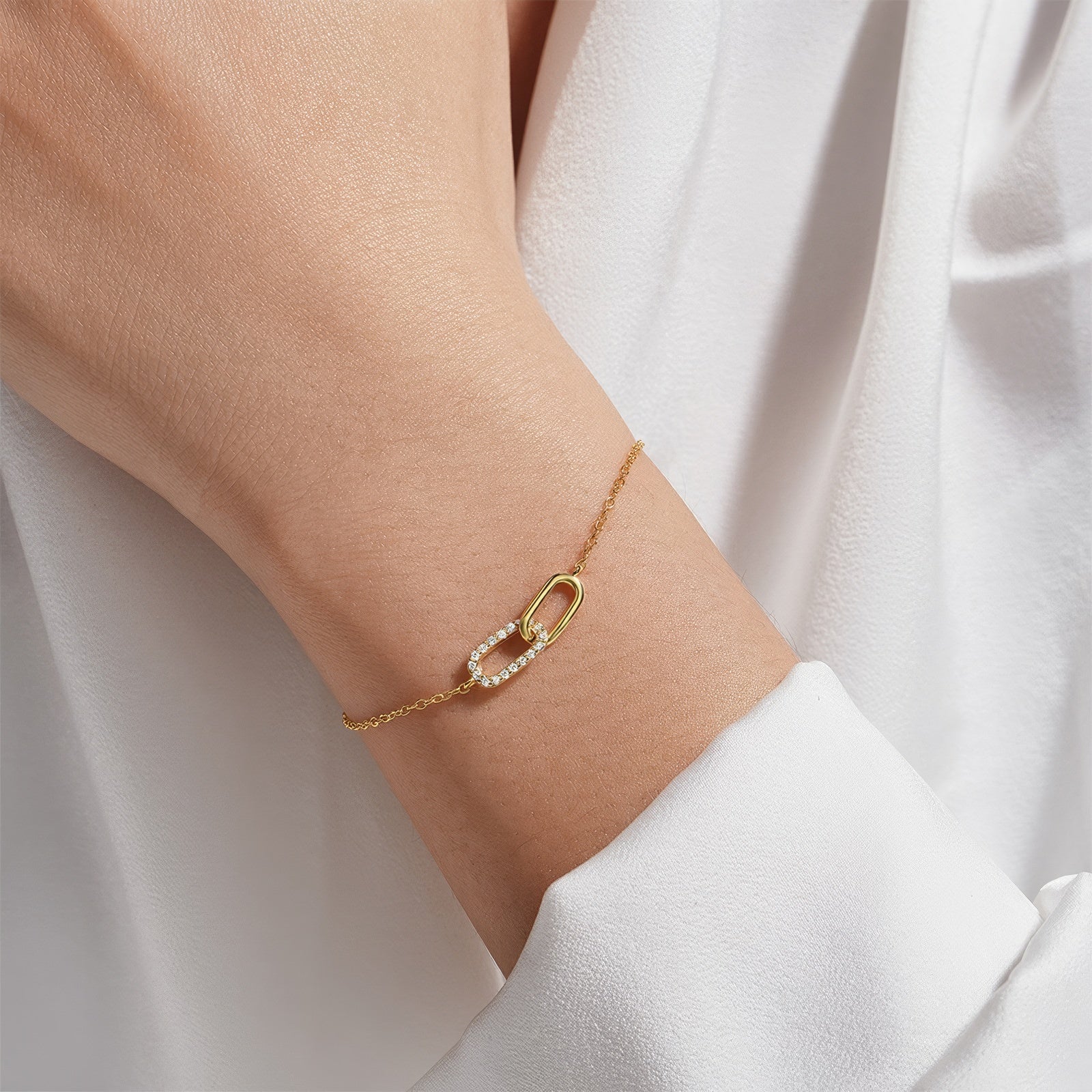 Interlocking zirconia link bracelet in 925 sterling silver with two oval charms—one pavé zirconia—adjustable chain, available in gold & silver plating