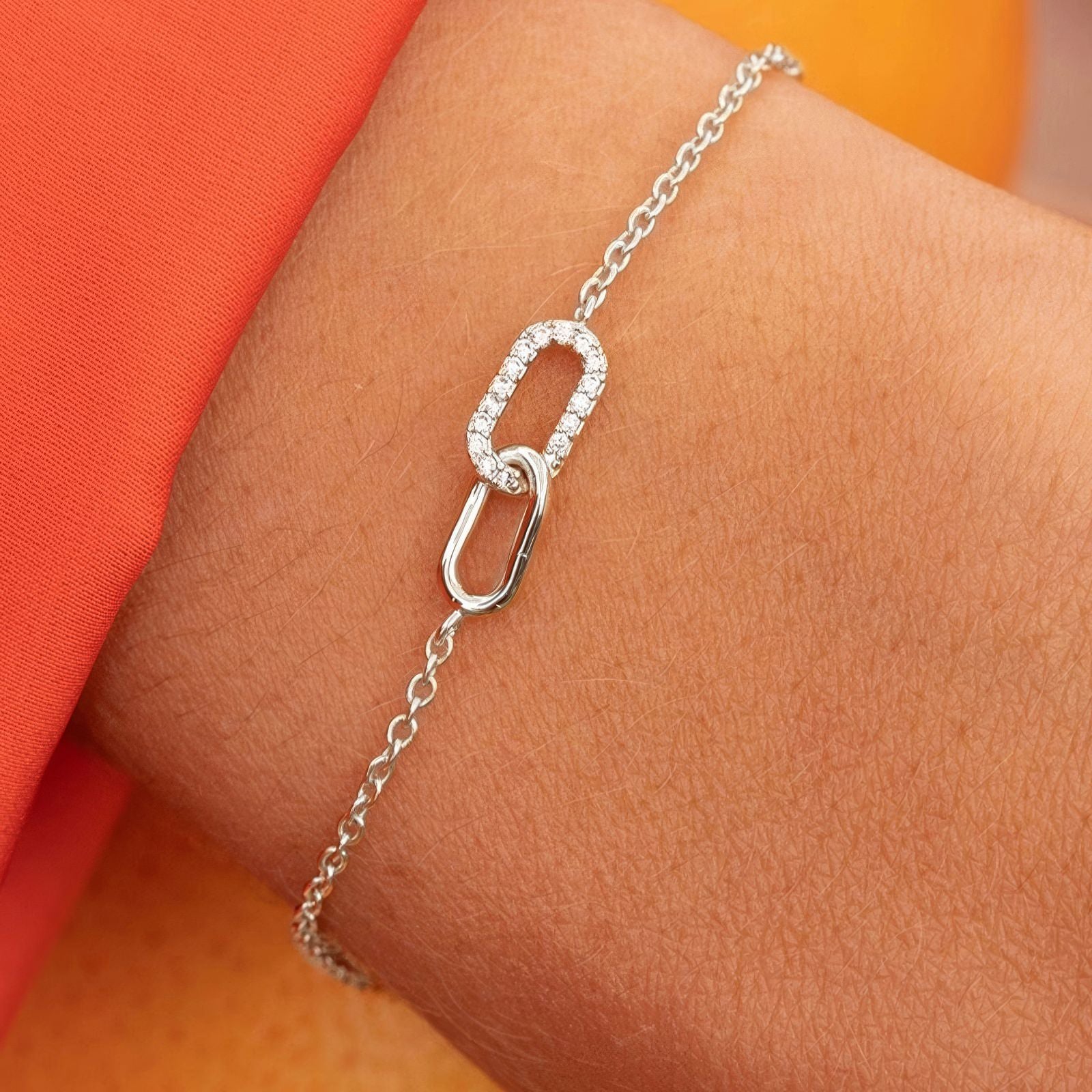 Interlocking zirconia link bracelet in 925 sterling silver with two oval charms—one pavé zirconia—adjustable chain, available in gold & silver plating