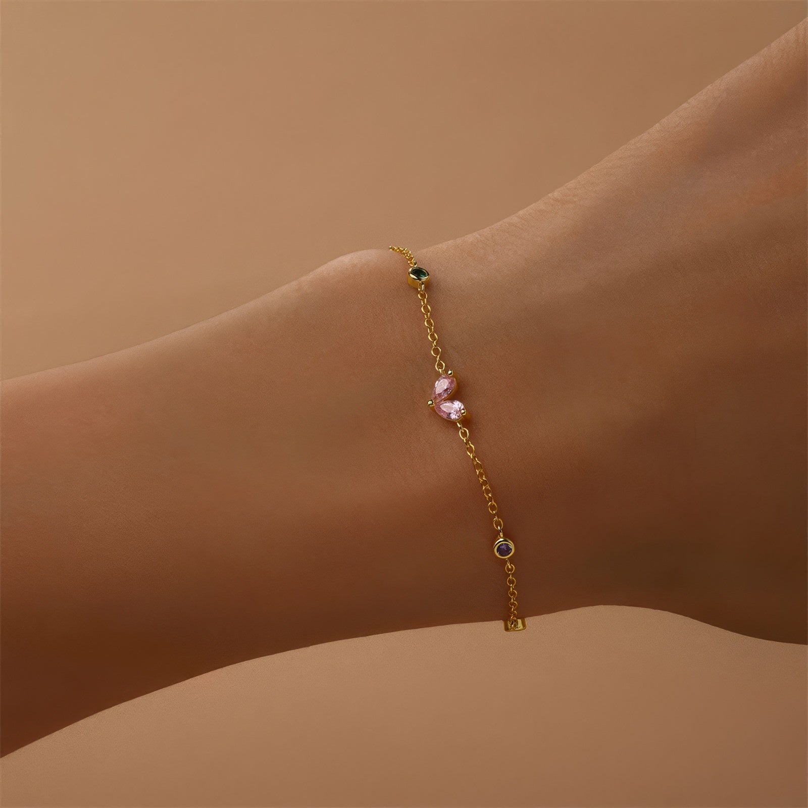 Gold-plated bracelet with pink heart-shaped zircon and multicolor zircon stones on a sterling silver chain.