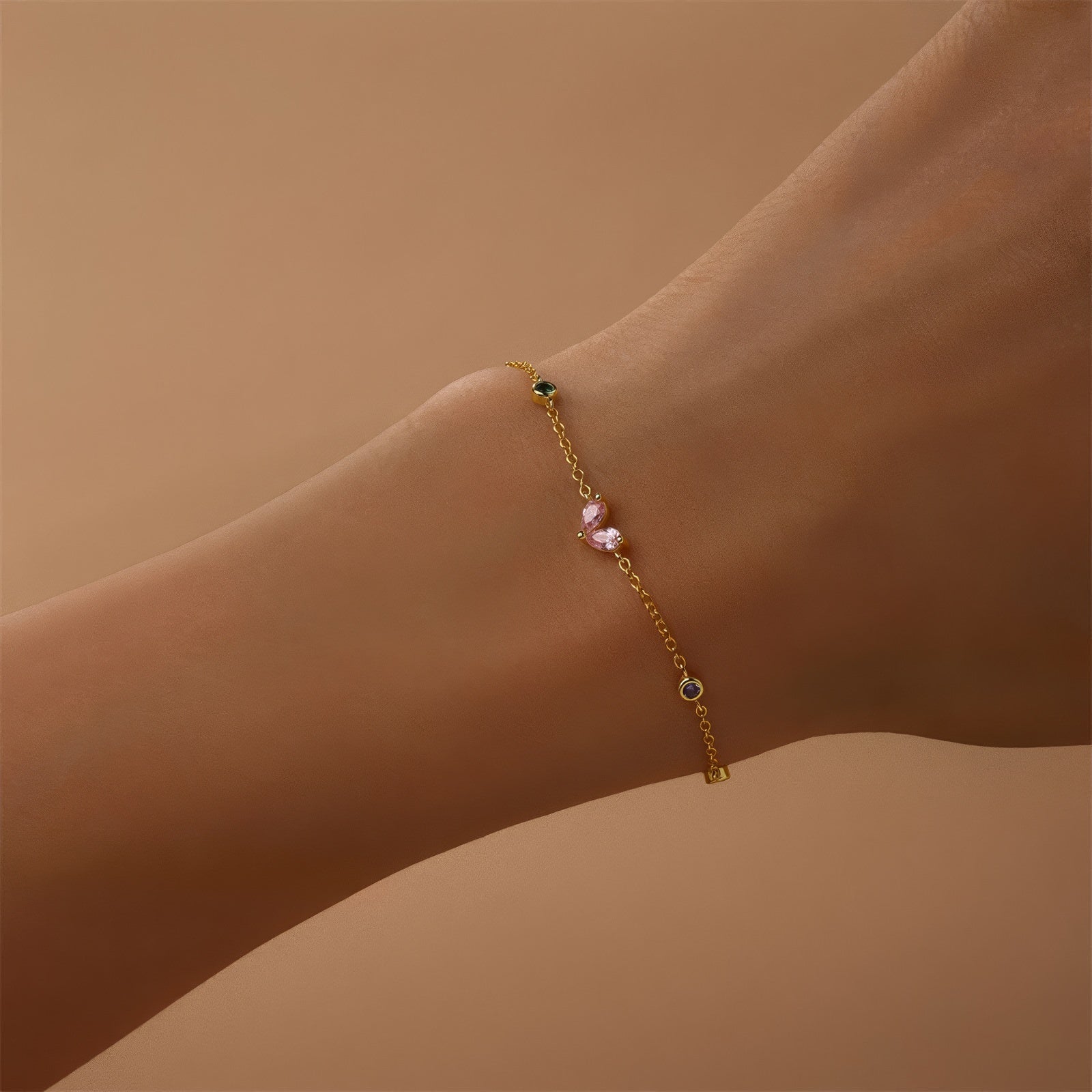 Gold-plated bracelet with pink heart-shaped zircon and multicolor zircon stones on a sterling silver chain.
