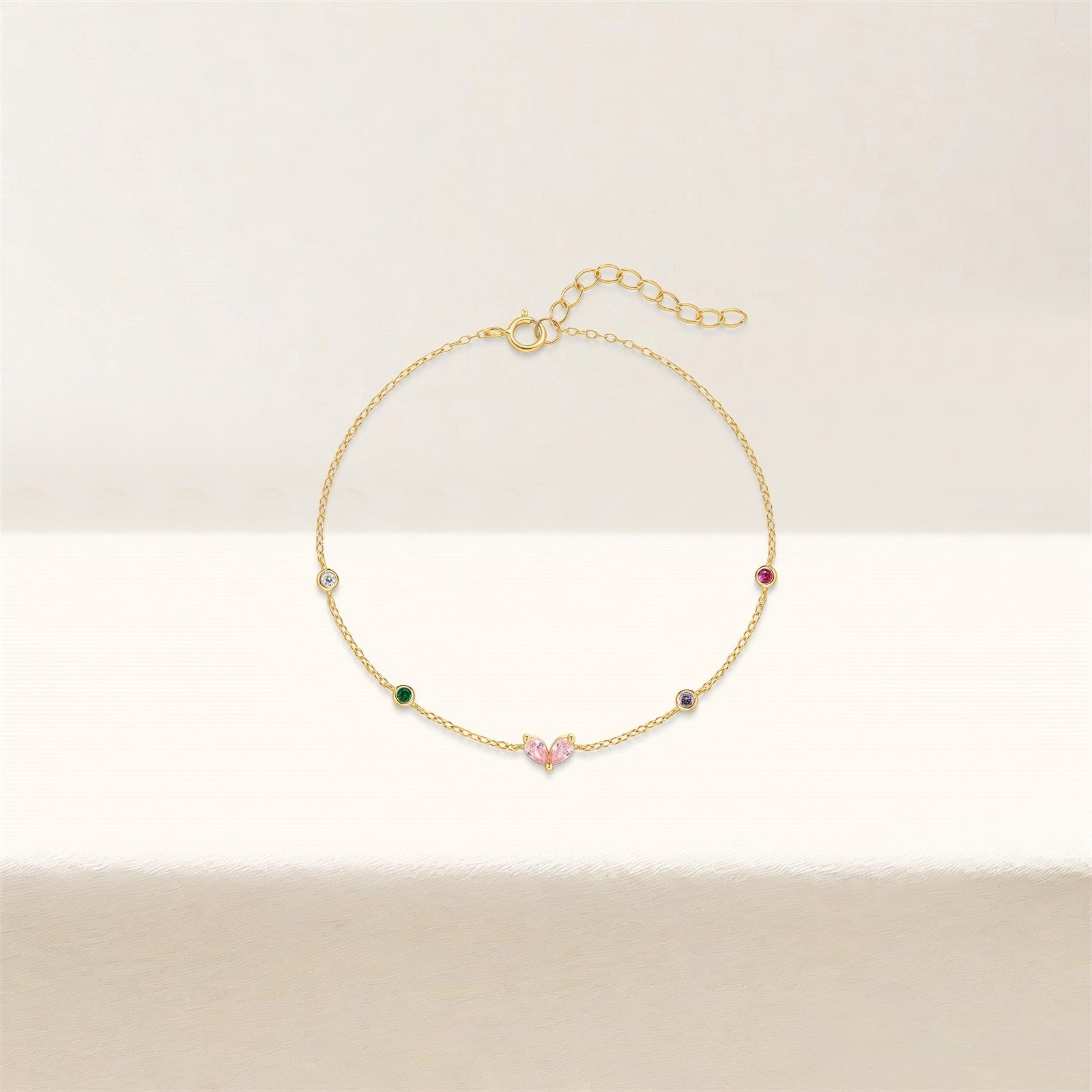 Gold-plated bracelet with pink heart-shaped zircon and multicolor zircon stones on a sterling silver chain.