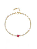 gold plated tennis bracelet with red heart-shaped crystal in the middle