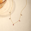 V-shape multicolor zirconia drop necklace in 925 sterling silver with 18K gold plating, adjustable chain, featuring red teardrop, pink baguette, marquise red, and purple square zirconia charms