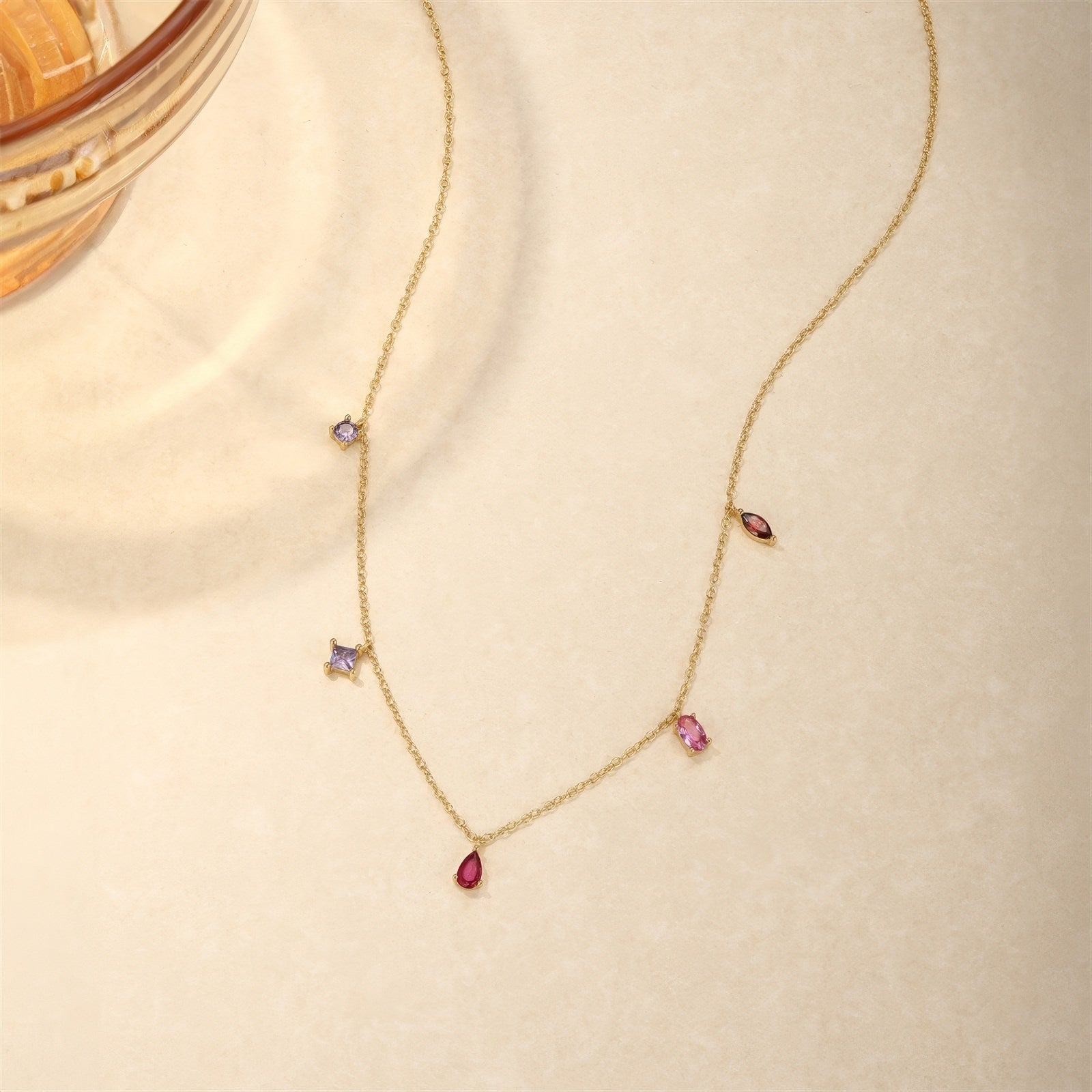 V-shape multicolor zirconia drop necklace in 925 sterling silver with 18K gold plating, adjustable chain, featuring red teardrop, pink baguette, marquise red, and purple square zirconia charms