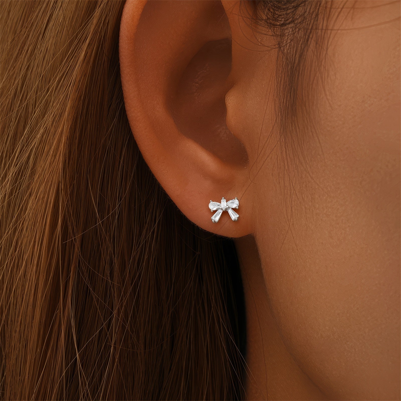 dainty bow shaped stud earrings in gold plated sterling silver made with zirconia crystals