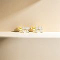 dainty bow shaped stud earrings in gold plated sterling silver made with zirconia crystals