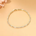 Gold tennis bracelet with alternating baguette and round zircon stones, 18K gold plated on copper, 3.5mm wide and 17cm long.