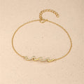 Gold bracelet with wave-shaped zircon design centerpiece on a sterling silver chain, finished with 18K gold plating.