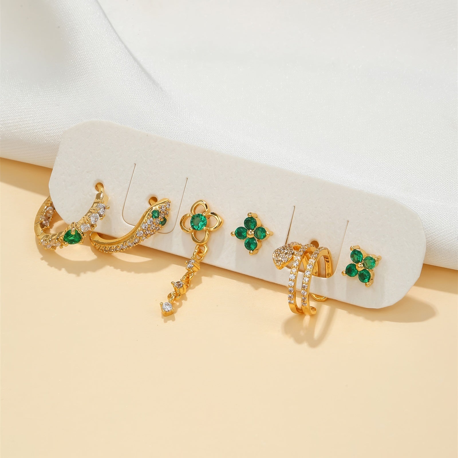 green crystals mismatched mini earrings set in gold plated stainless steel