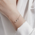 Interlocking zirconia link bracelet in 925 sterling silver with two oval charms—one pavé zirconia—adjustable chain, available in gold & silver plating
