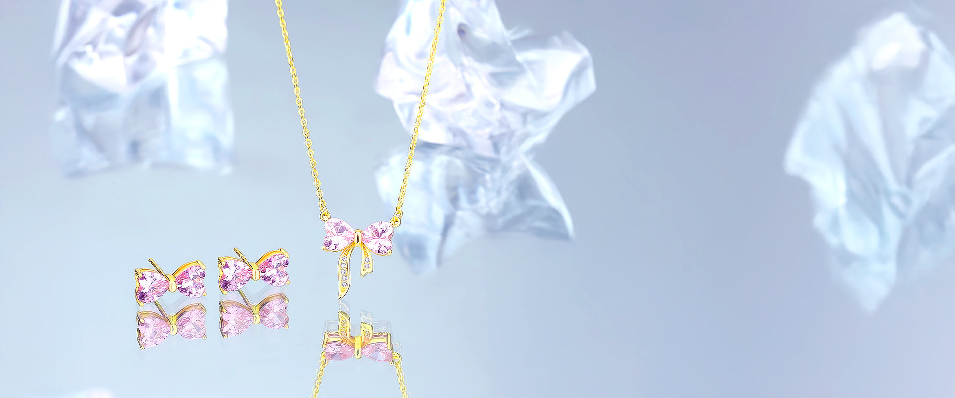 pink crystal bow necklace and stud setting in goldslider_item_cqLqUq
