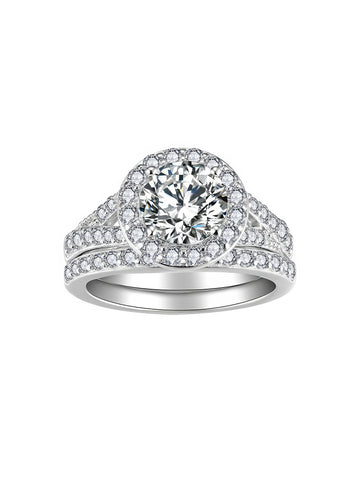 Sterling silver bridal ring set with round-cut moissanite center stone and halo, featuring a pavé split band and matching wedding band with moissanite stones