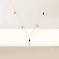 V-shape multicolor zirconia drop necklace in 925 sterling silver with 18K gold plating, adjustable chain, featuring red teardrop, pink baguette, marquise red, and purple square zirconia charms